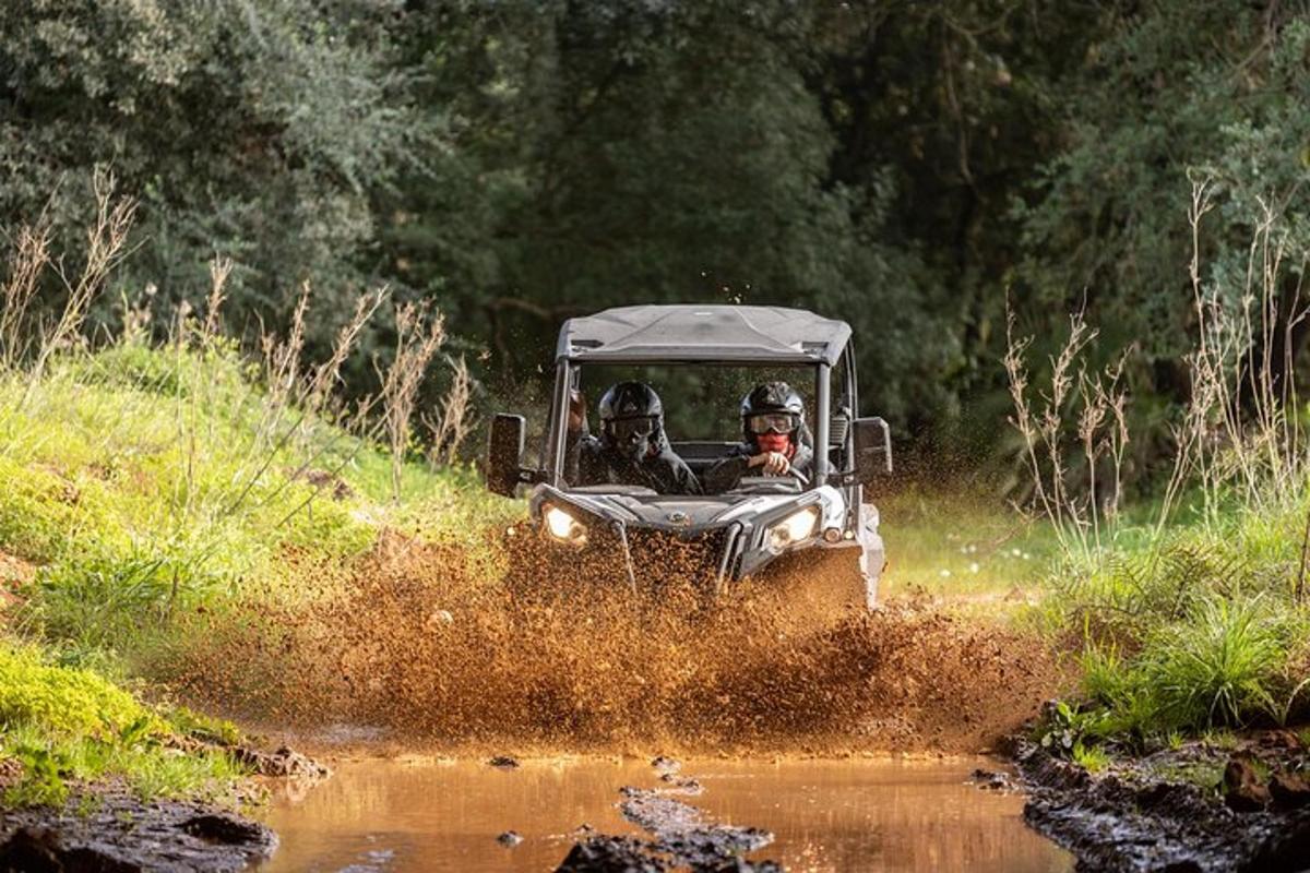a person in a jeep driving through the mud