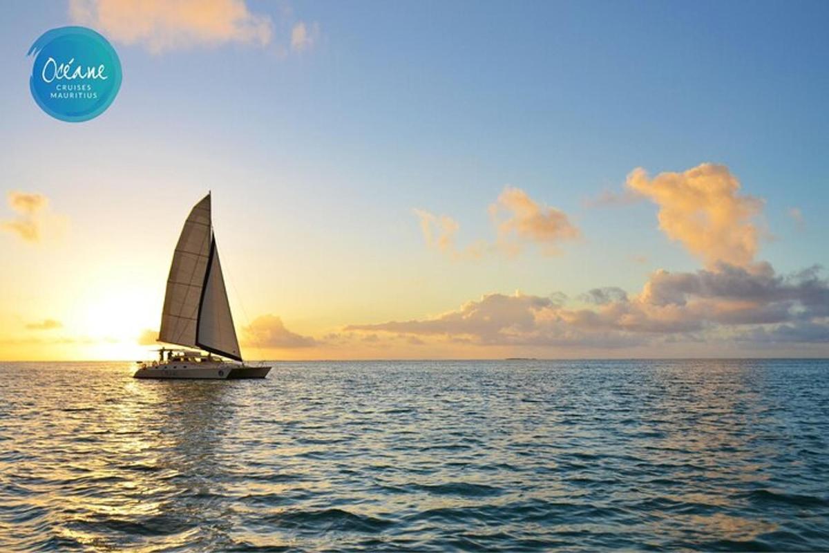 a sailboat on the water with a sunset