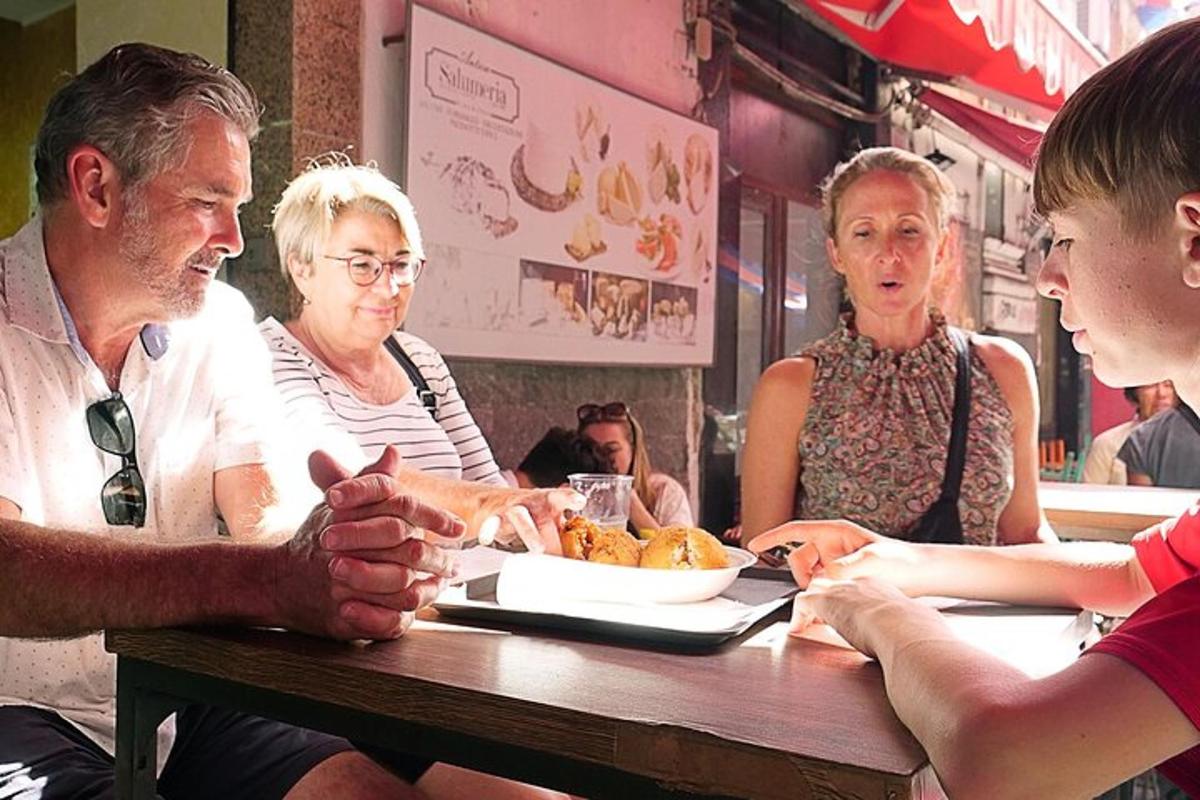 a group of people sitting at a table eating food