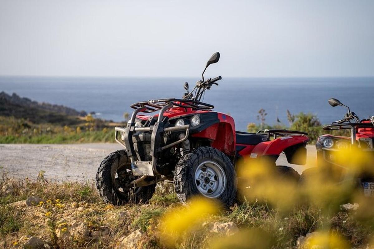 a red atv parked on the side of a hill