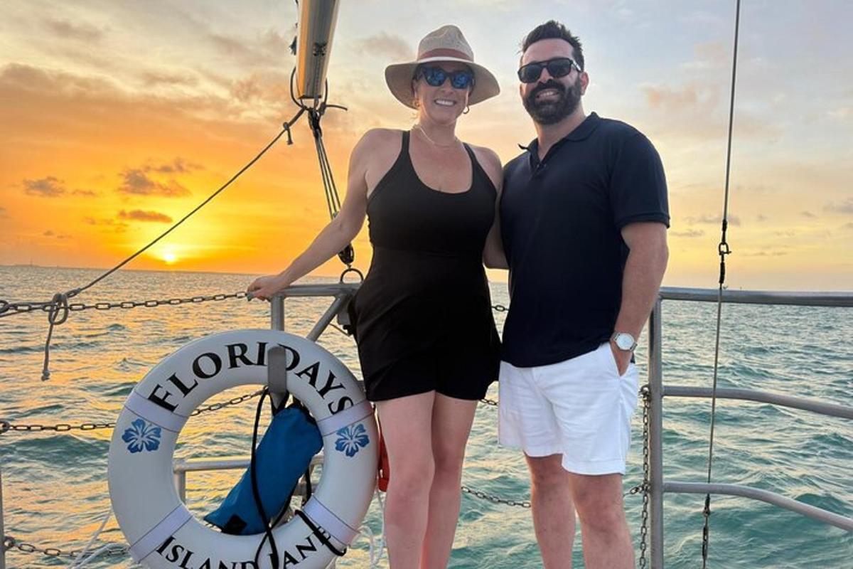 a man and a woman standing on a boat