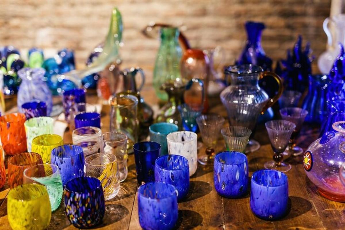 a group of colorful glass vases sitting on a table