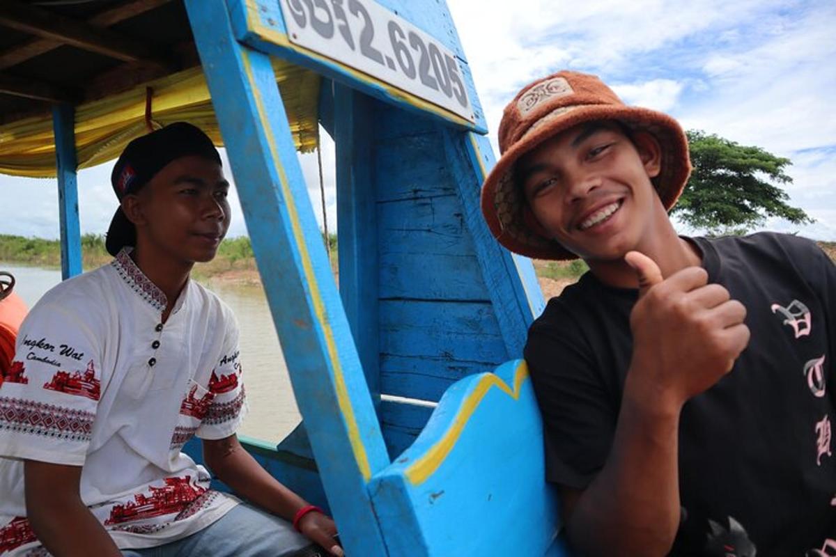 two men sitting on a bus giving a thumbs up