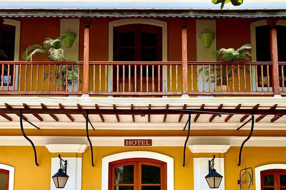 a building with a balcony with a hotel sign on it