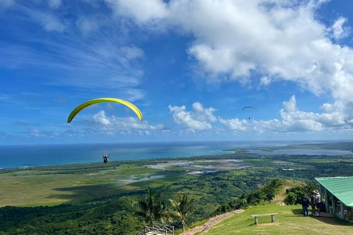 a person is flying a parachute over the ocean