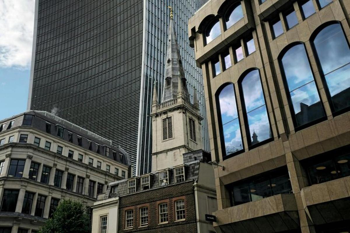 a building with a steeple in the middle of some buildings