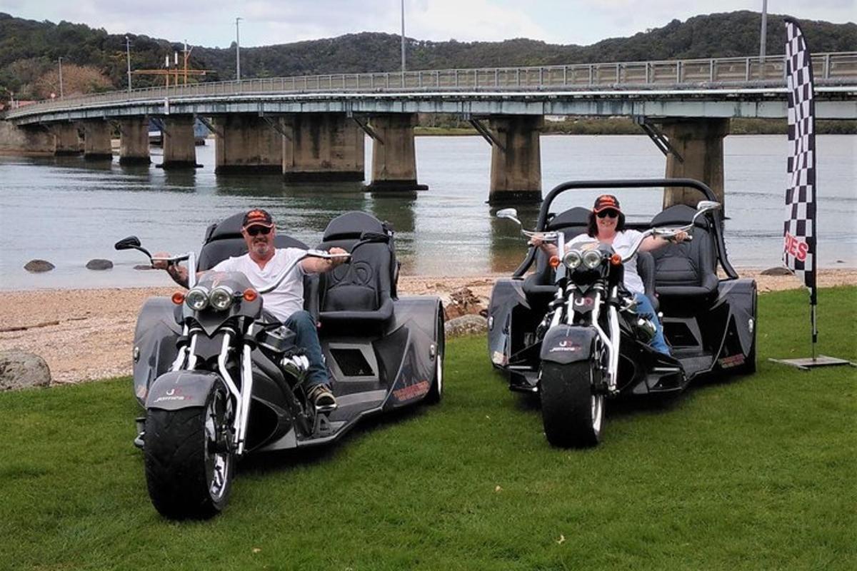 two people riding motorcycles with a side car