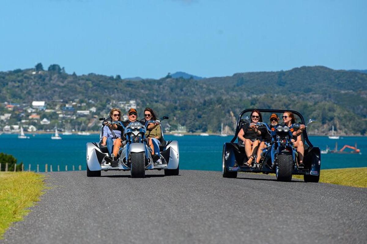 a group of people riding on the back of a three wheel vehicle