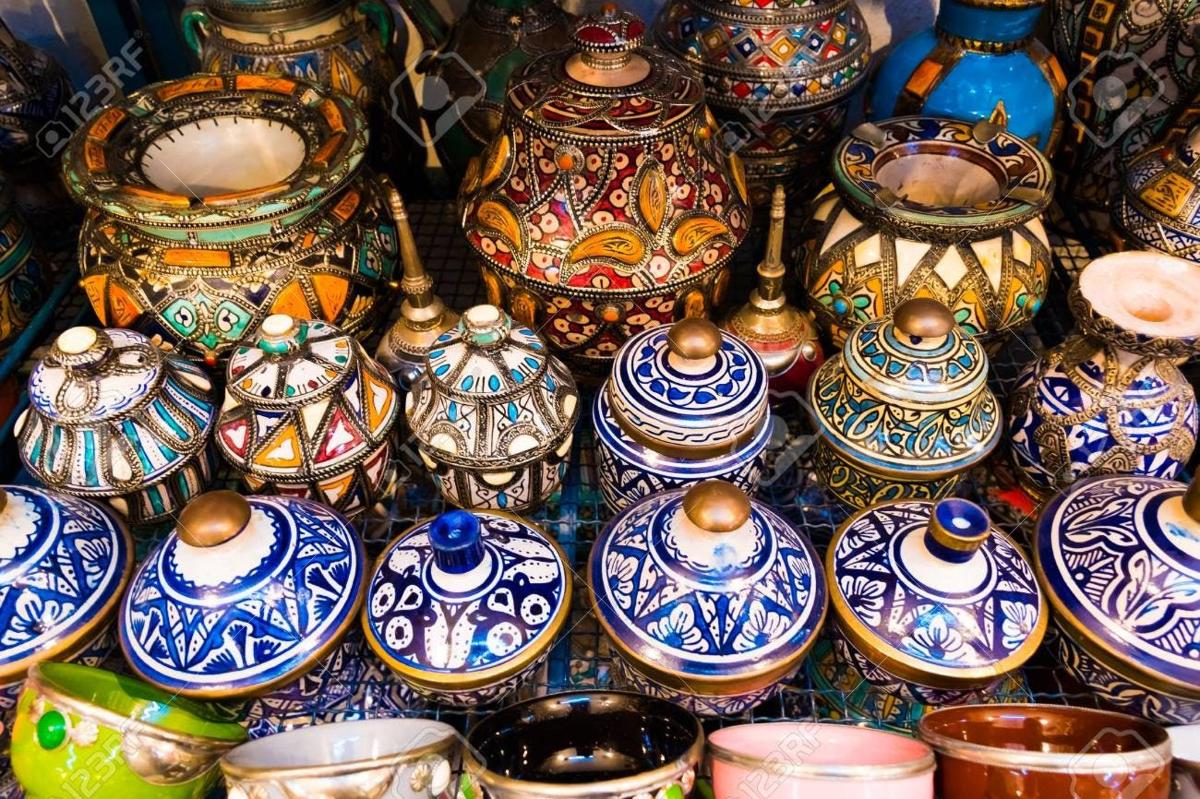 a pile of colorful vases on display in a store