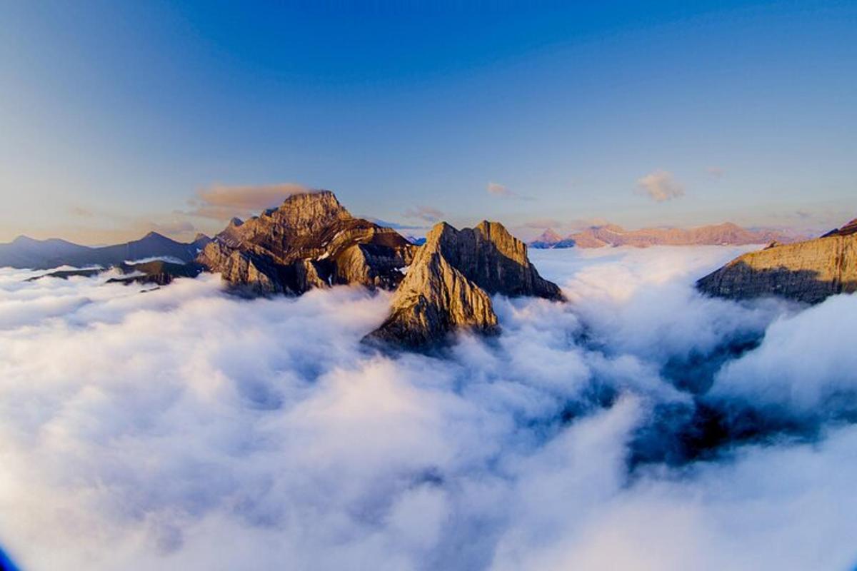a view of a mountain range above the clouds