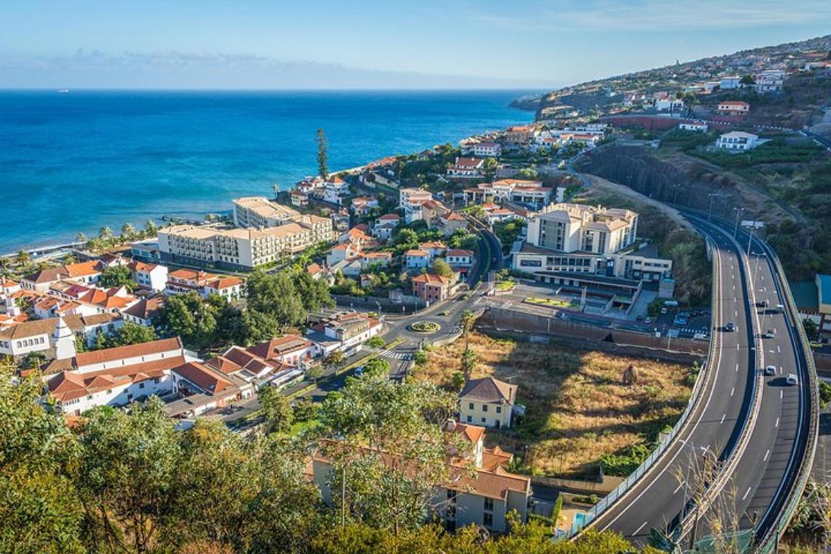 μια πόλη σε έναν λόφο με έναν δρόμο και τον ωκεανό