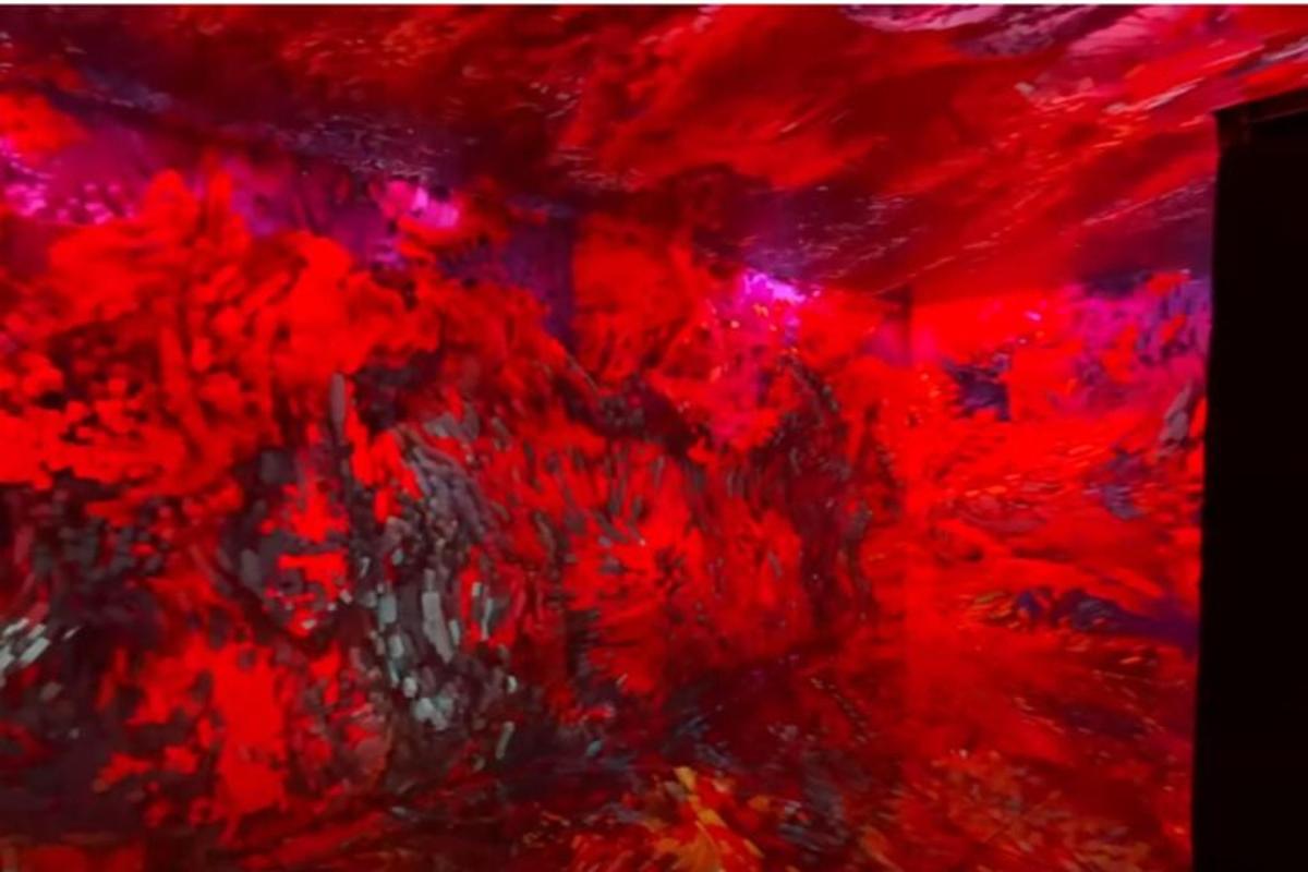 a close up of a painting with red