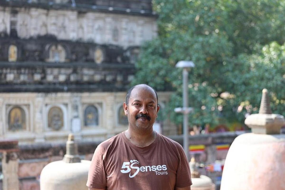 a man with a mustache standing in front of a building