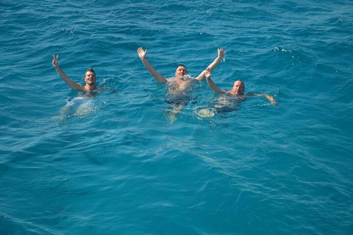 Τρία άτομα στο νερό με τα χέρια τους στο νερό
