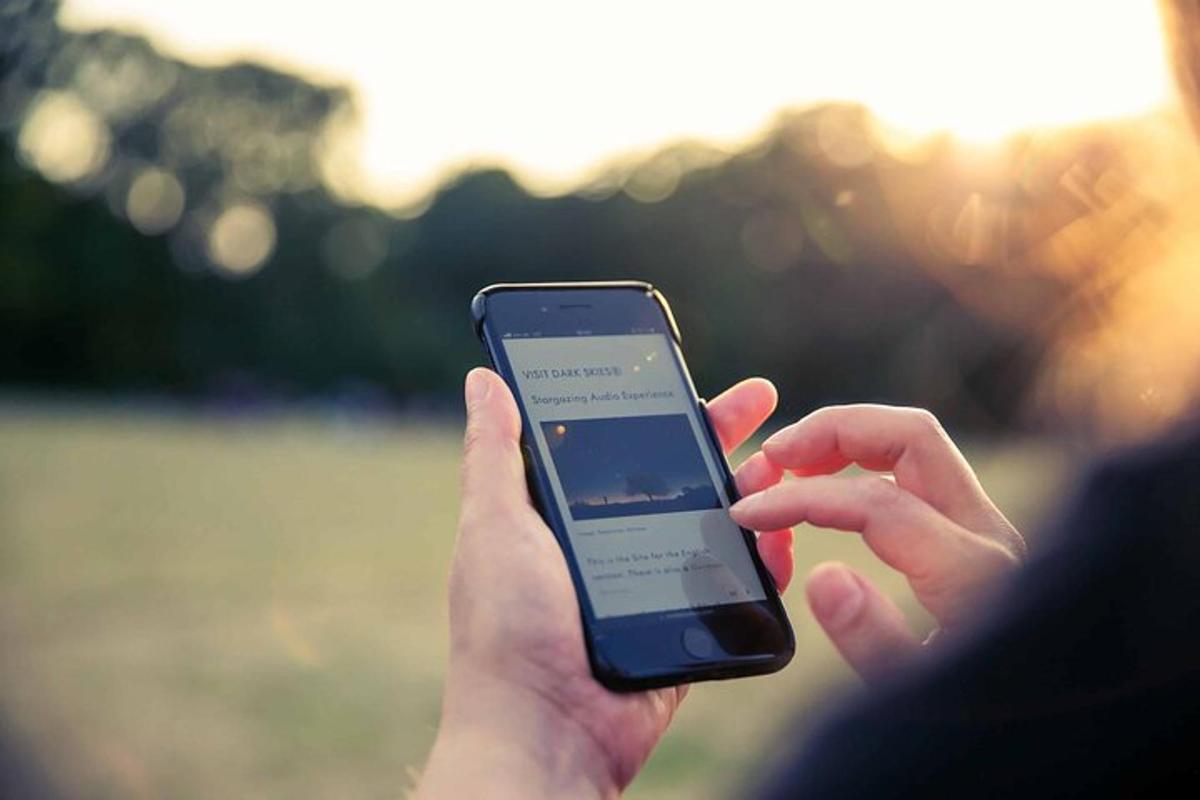 a person holding a cell phone in their hand