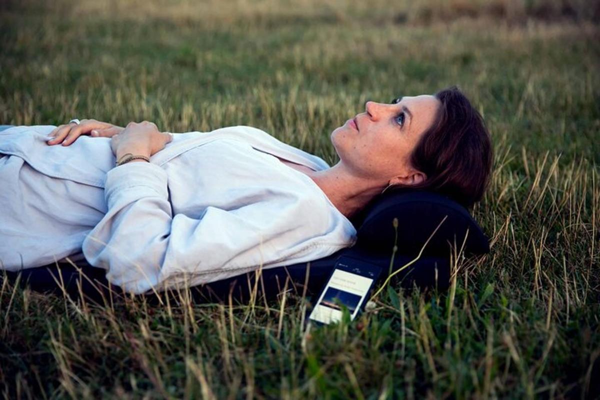a woman laying on the grass in a field