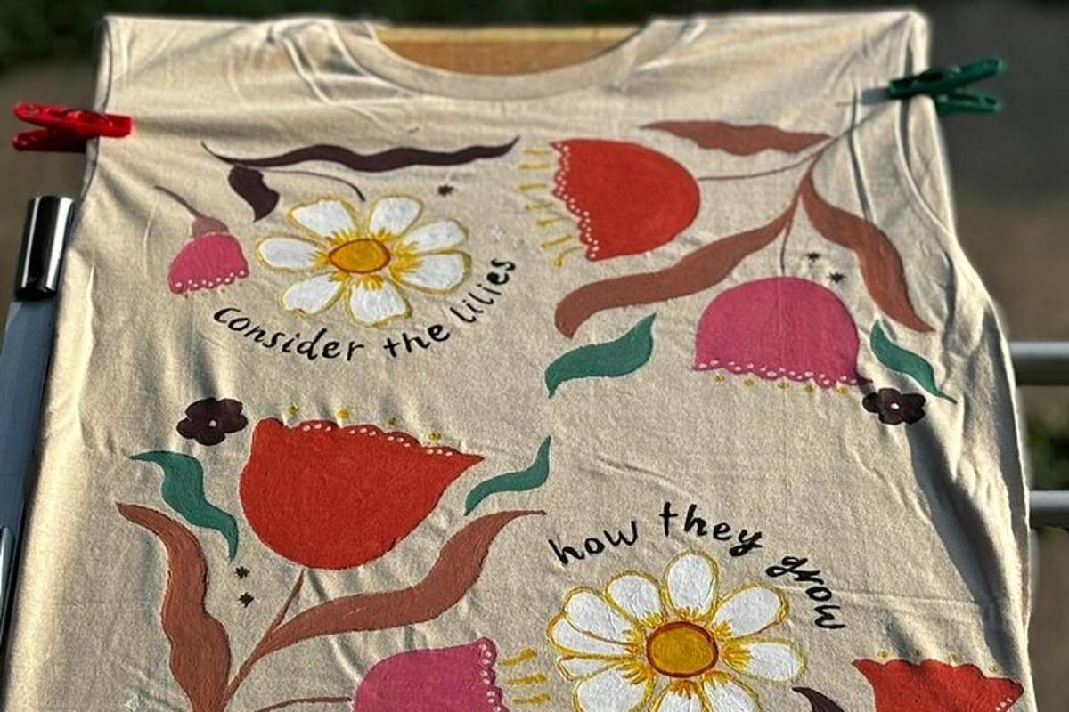 a shirt with flowers on it with the words consider the flowers how they soar