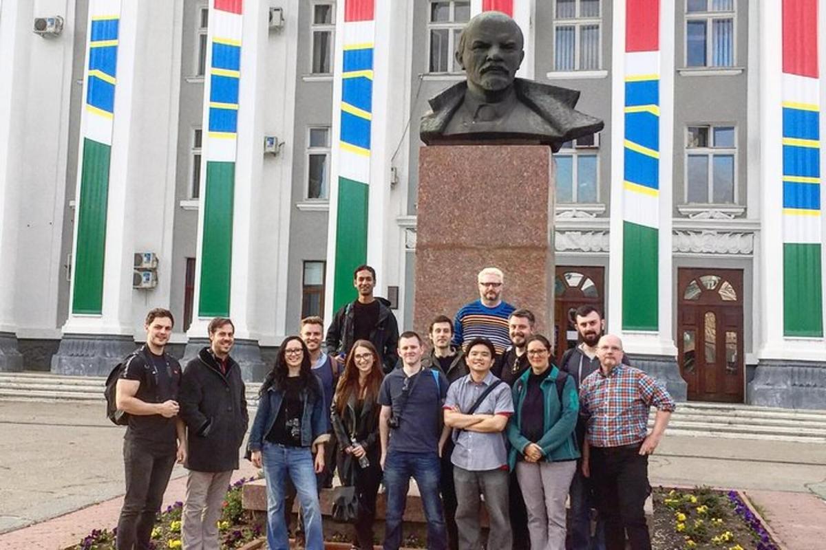 a group of people standing in front of a statue