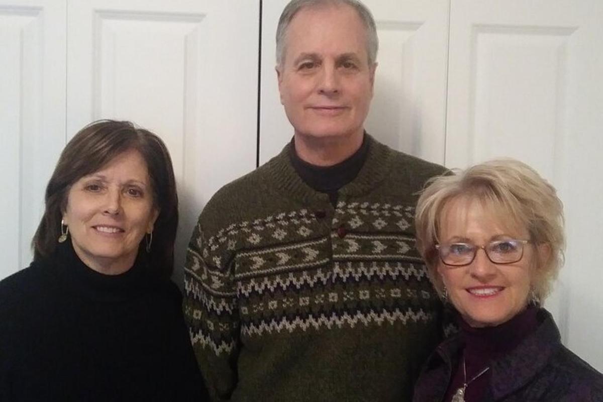 a man and two women posing for a picture