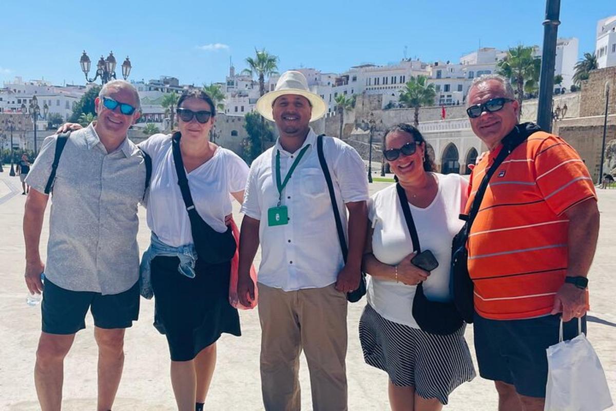 a group of people posing for a picture on the beach