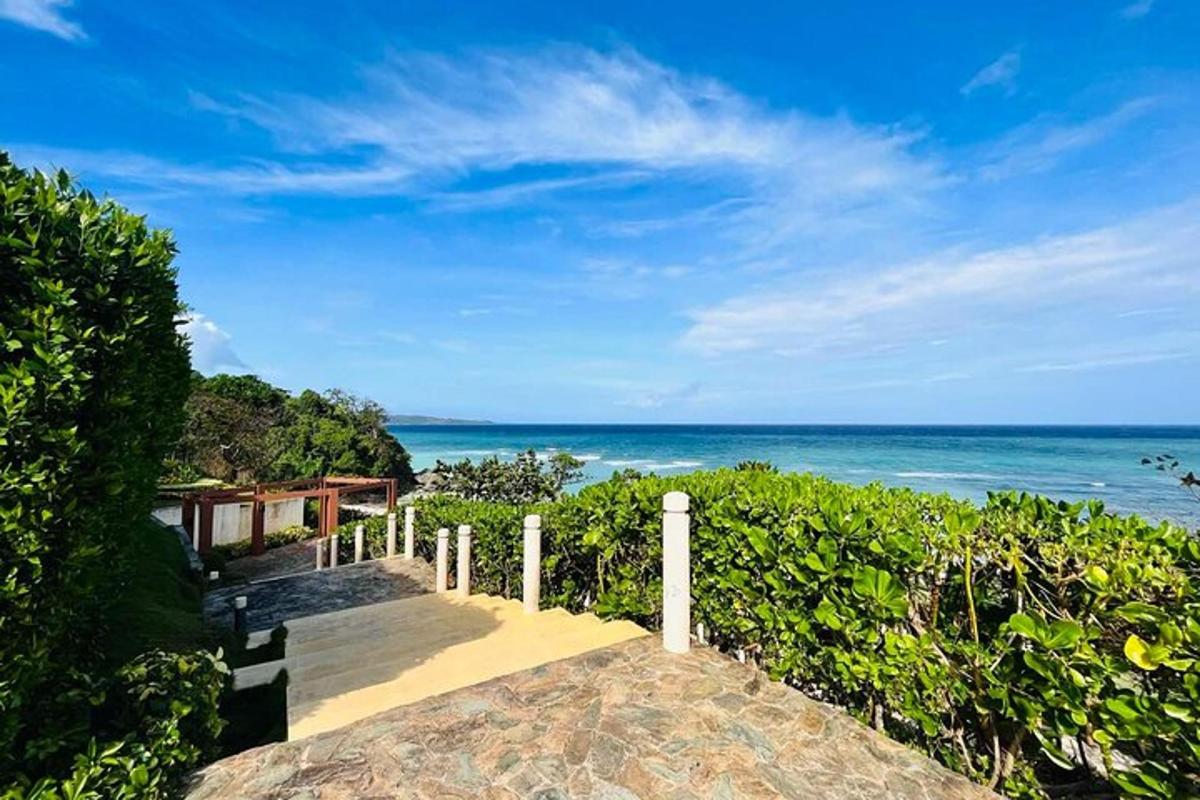 a stairway leading down to a beach with the ocean