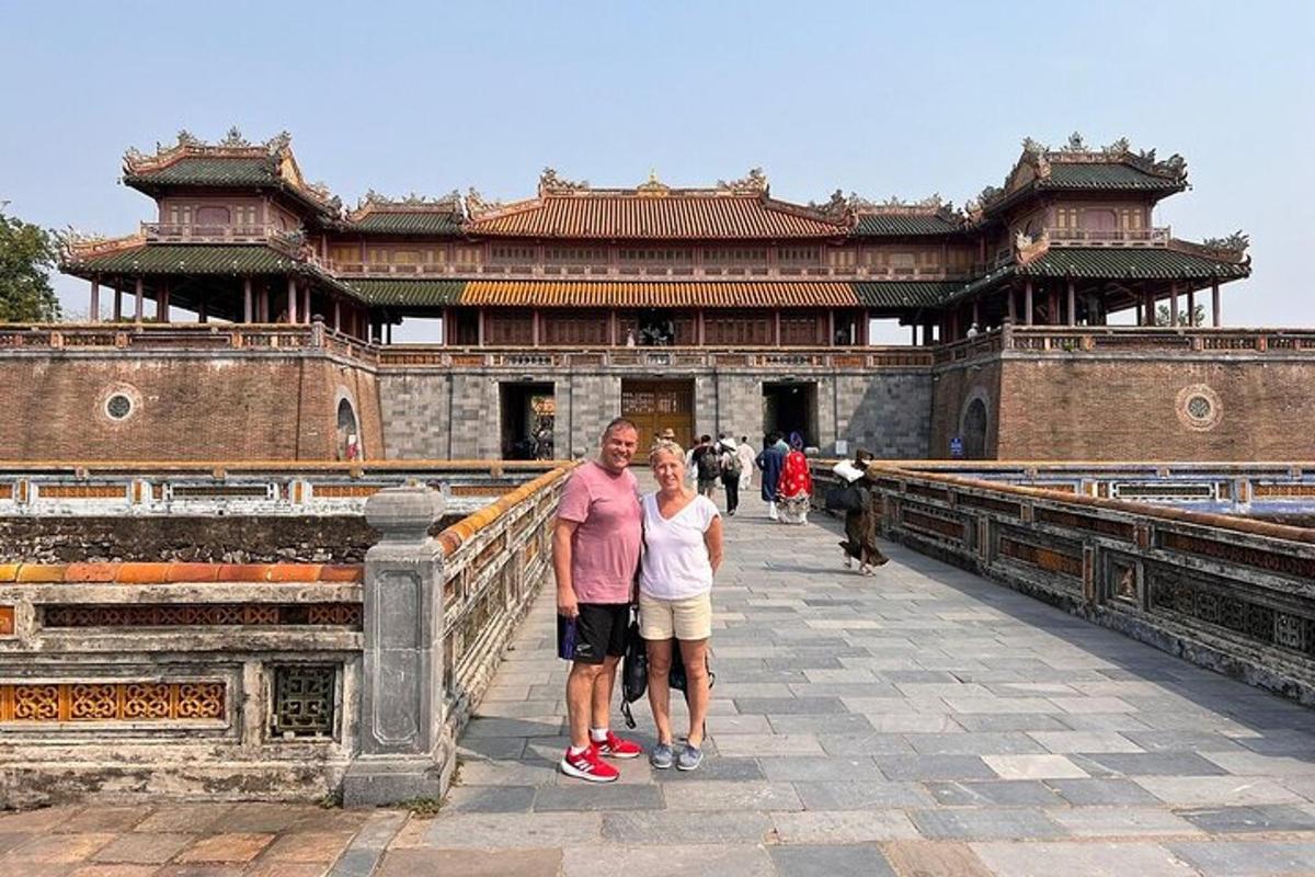 a man and a woman standing in front of a building