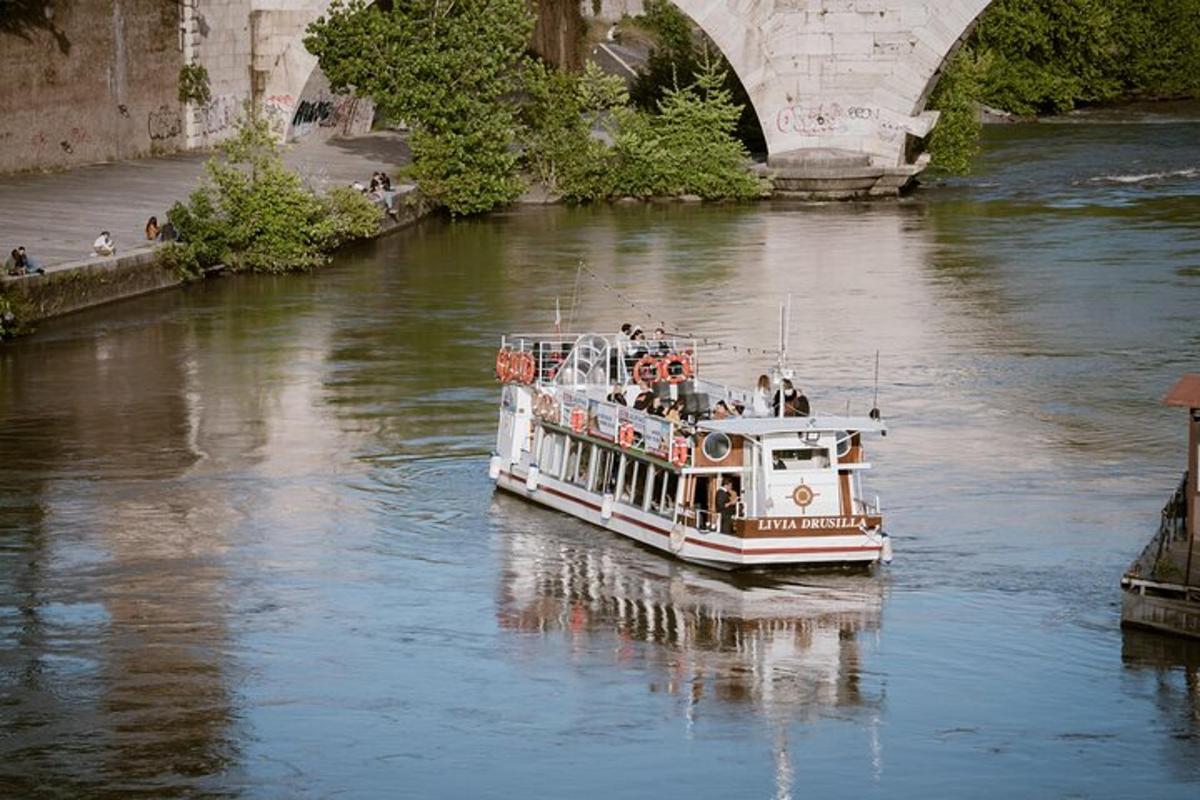 a boat traveling down a river under a bridge