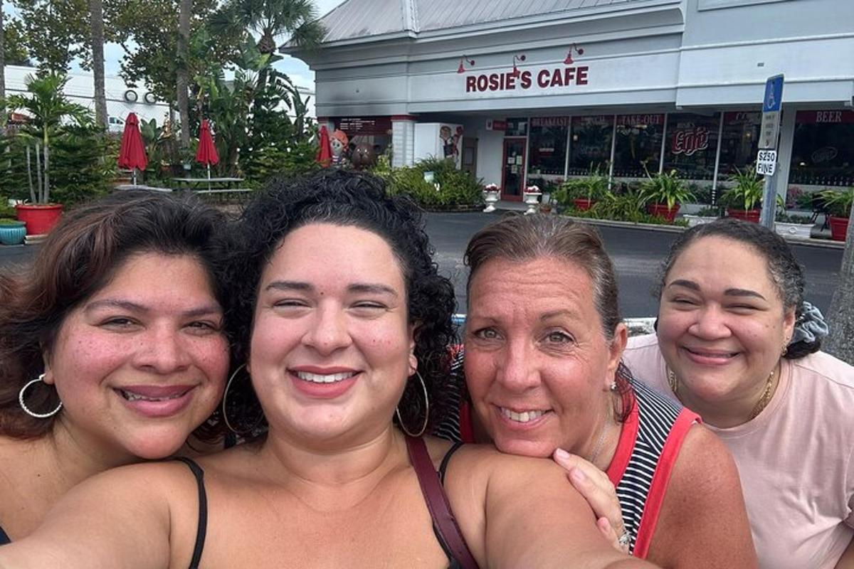 four women posing for a picture in front of a store