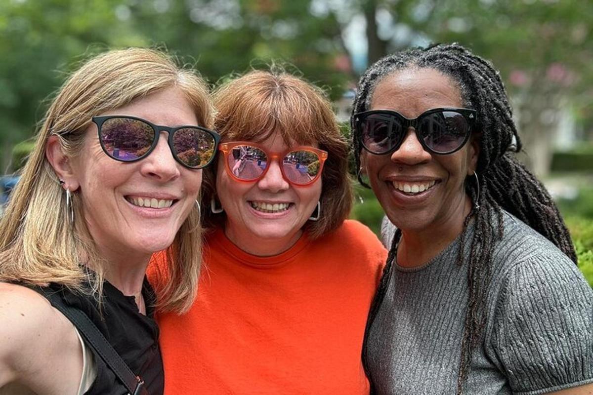 three women wearing sunglasses posing for a picture