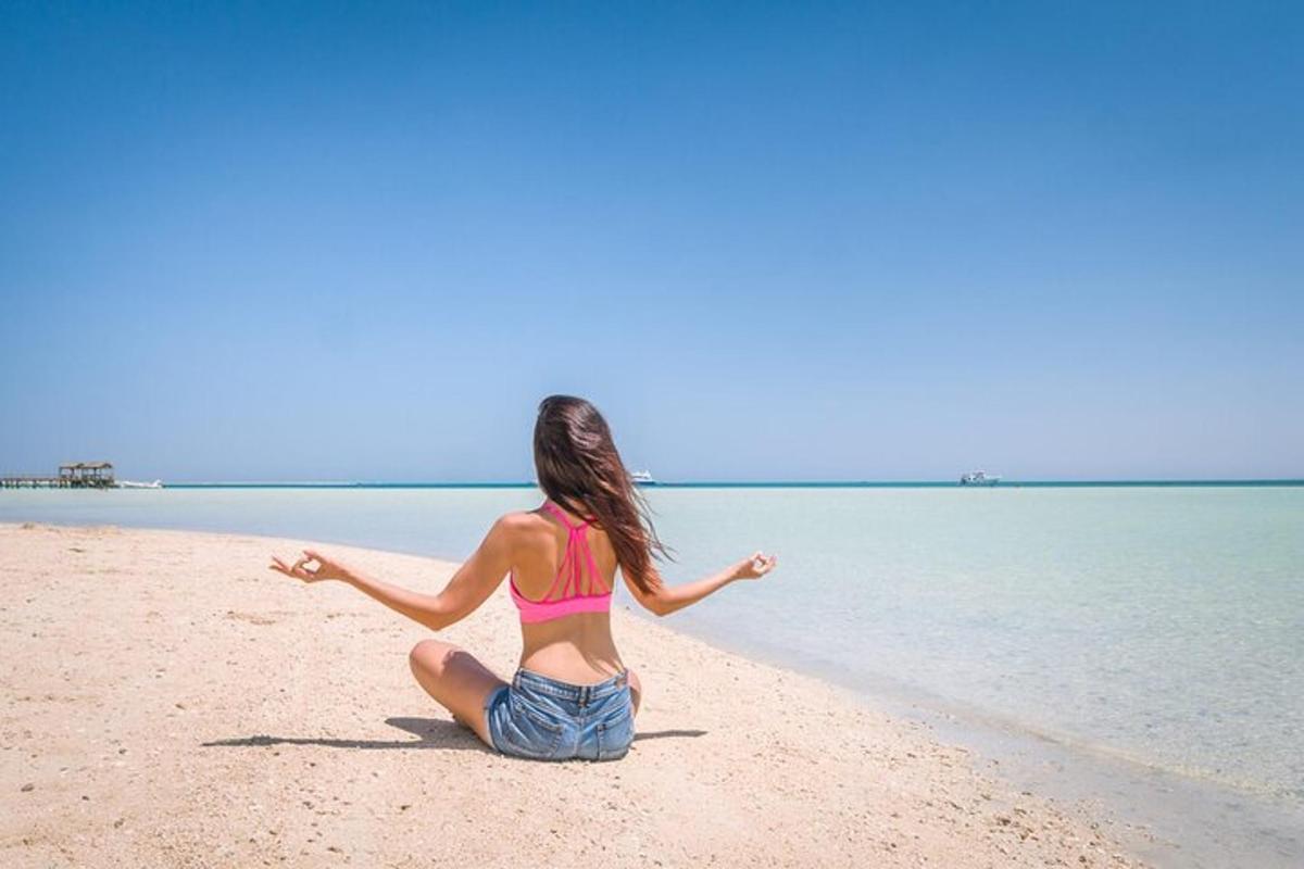 a woman in a bikini sitting on the beach