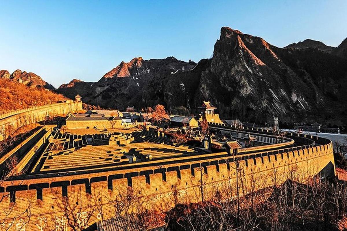 a view of a castle with mountains in the background