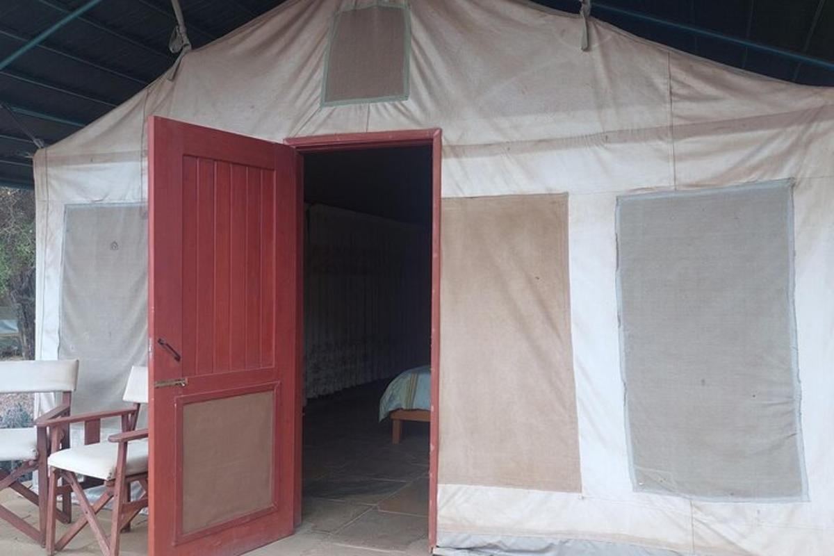 a tent with a red door and chairs in it