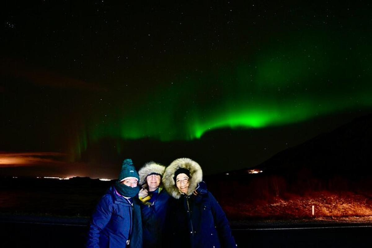 kolm inimest seisavad roheliste virmaliste all