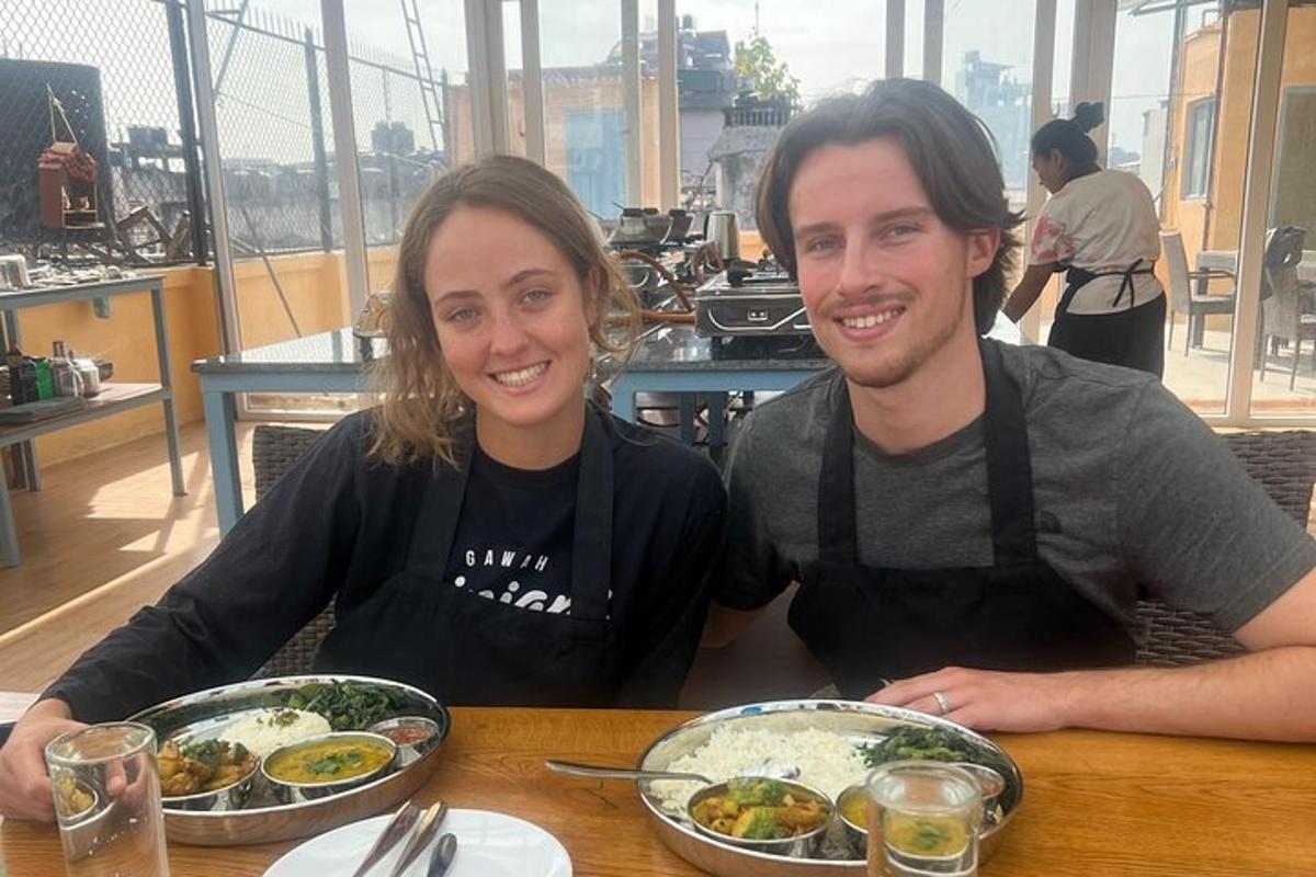a man and a woman sitting at a table with food