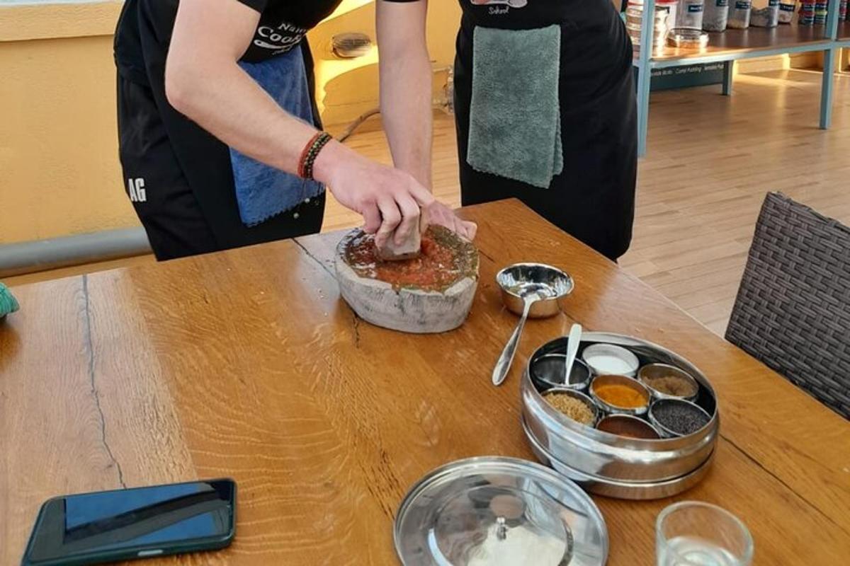 a woman preparing food in a bowl on a table