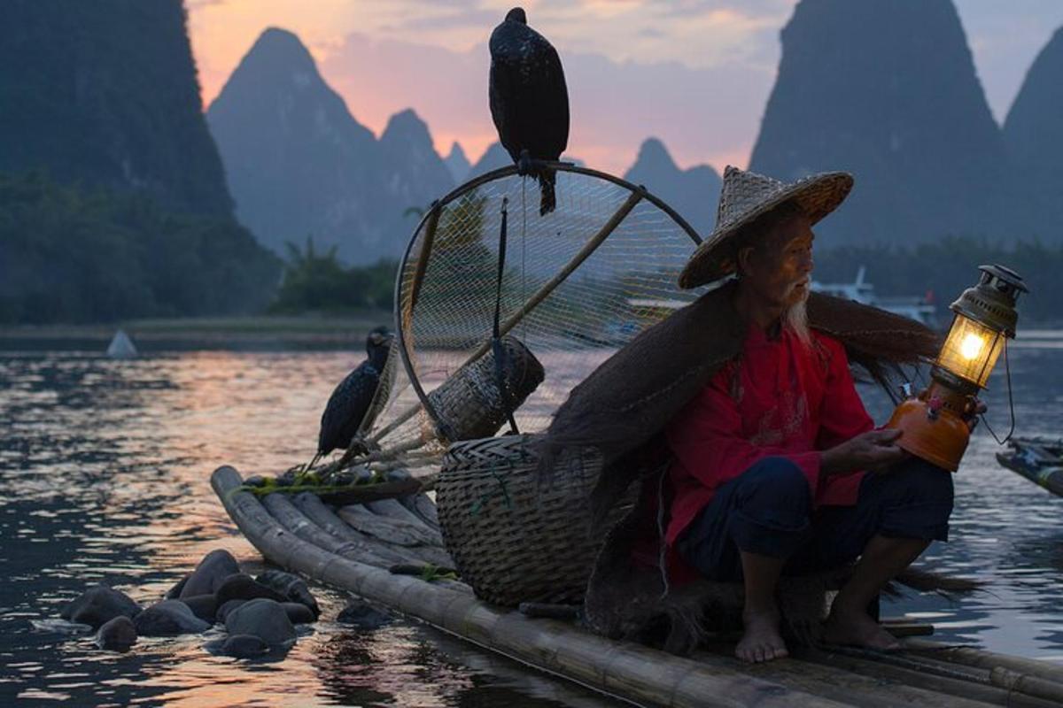 a man sitting on a raft with a bird on his basket