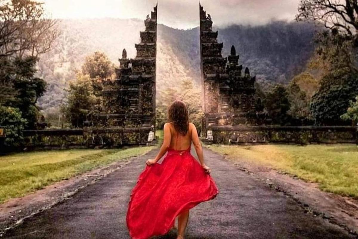 una donna in un vestito rosso che cammina lungo una strada