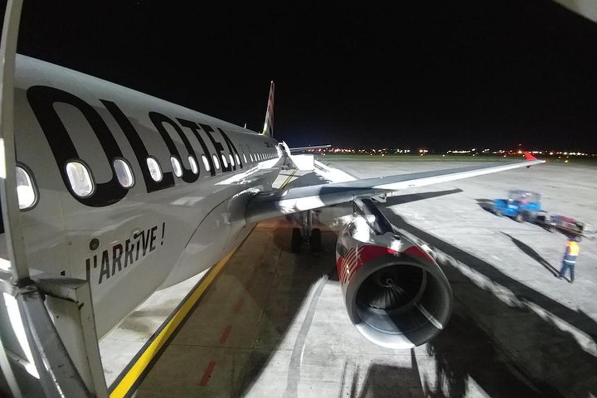 a plane parked on the runway at an airport