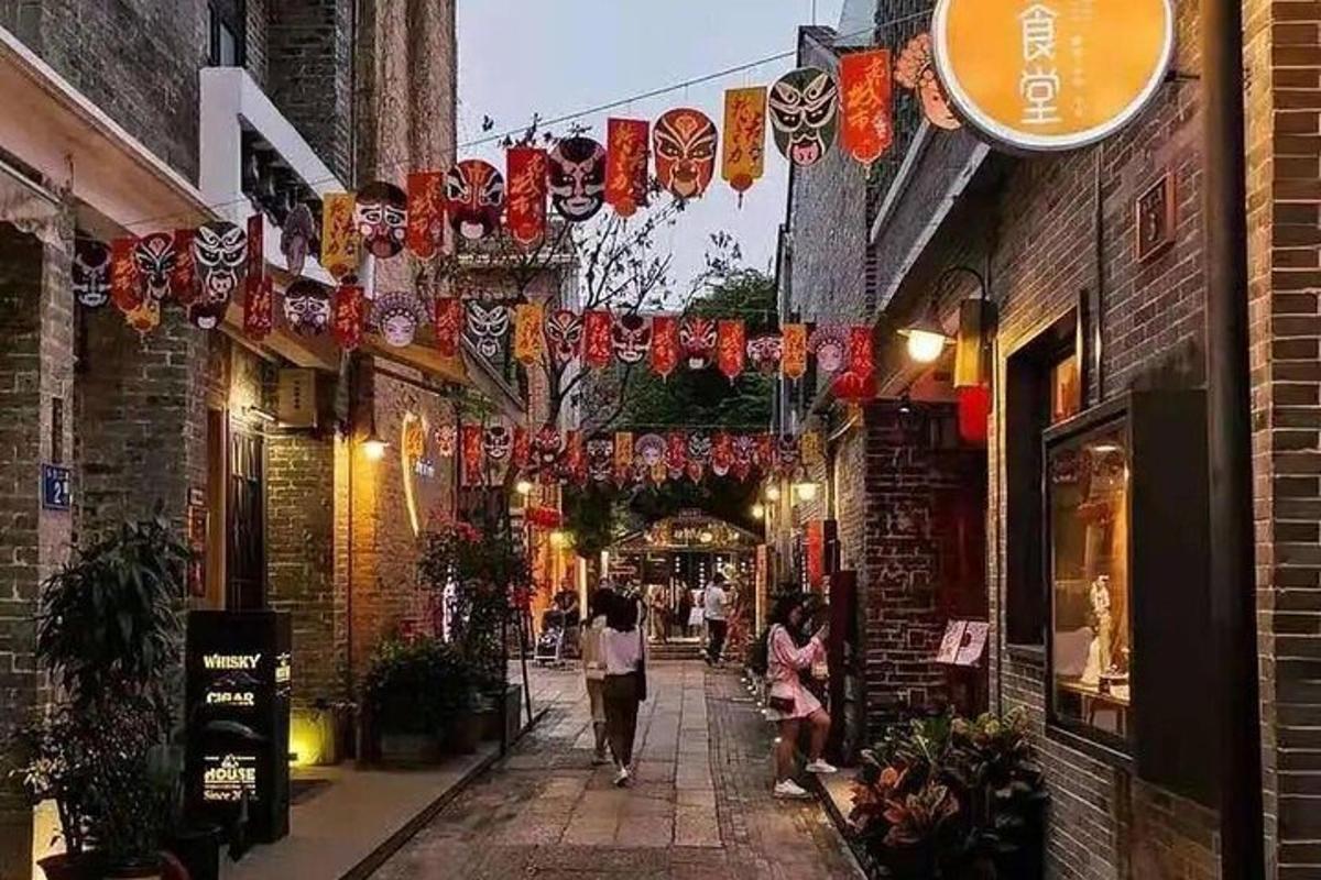a street with lanterns and people walking down a alley