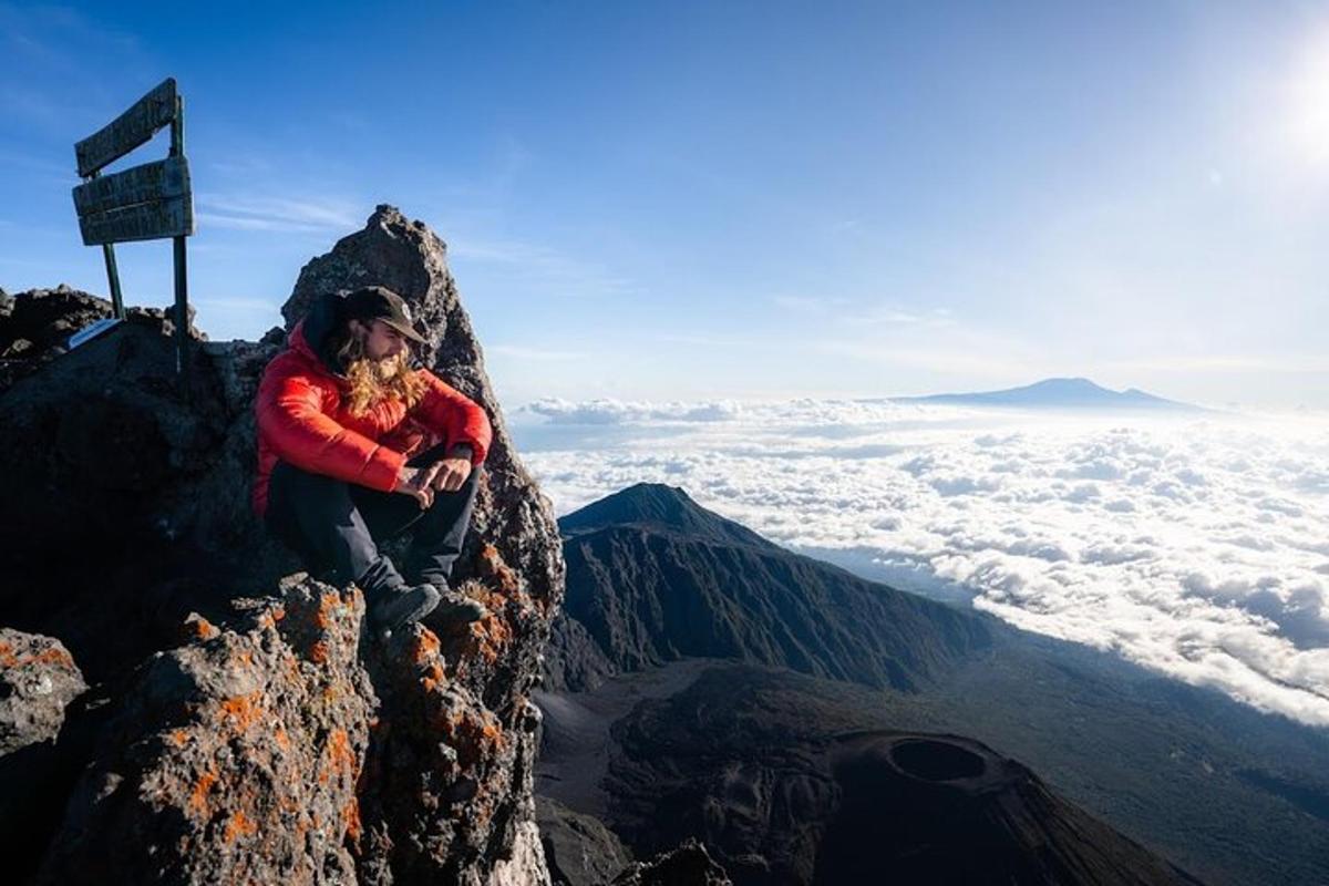 a person sitting on the top of a mountain