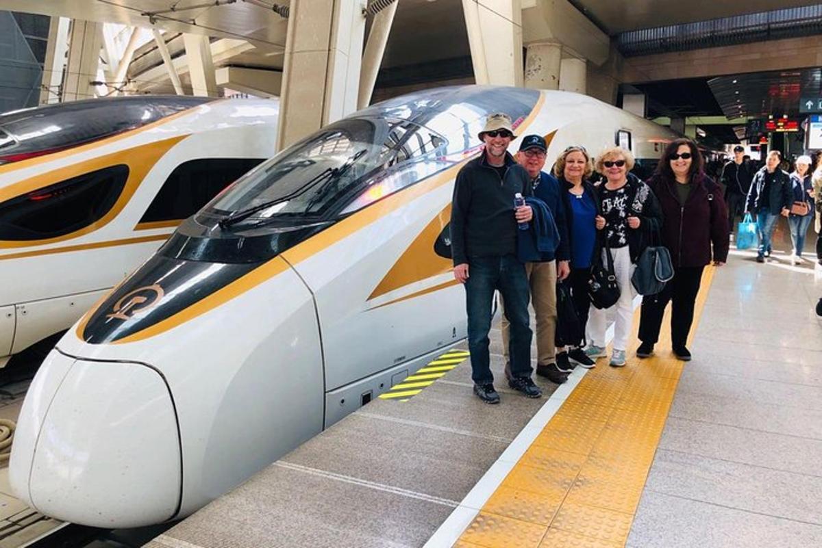 a group of people standing next to a train