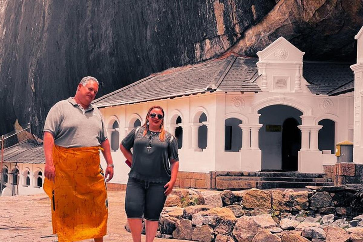 a man and a woman standing in front of a building
