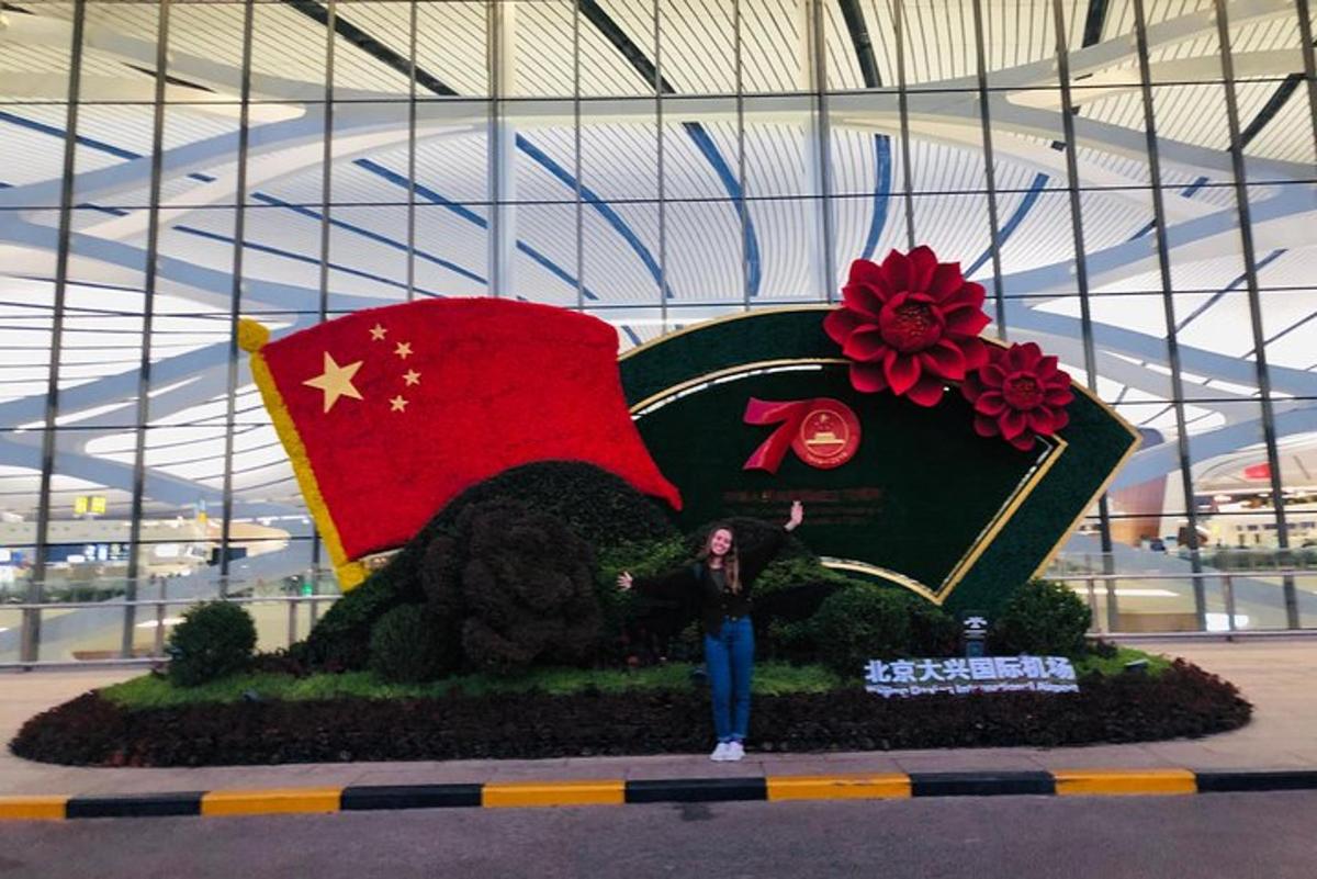 a person standing in front of a display of a train