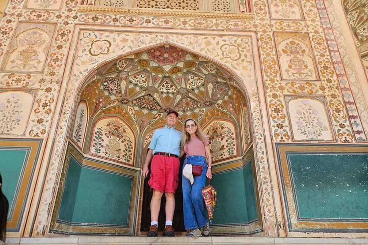 a man and a woman standing in front of an arch