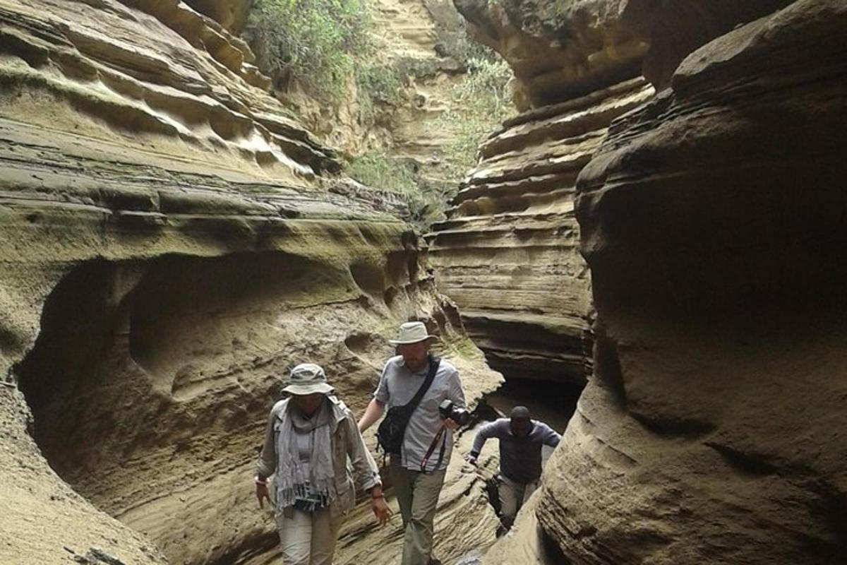 a group of people walking through a canyon