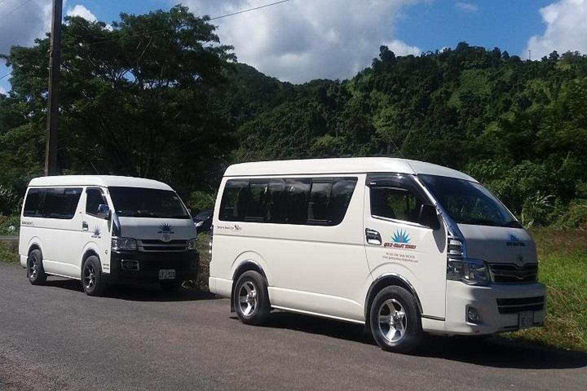 two white vans parked on the side of a road