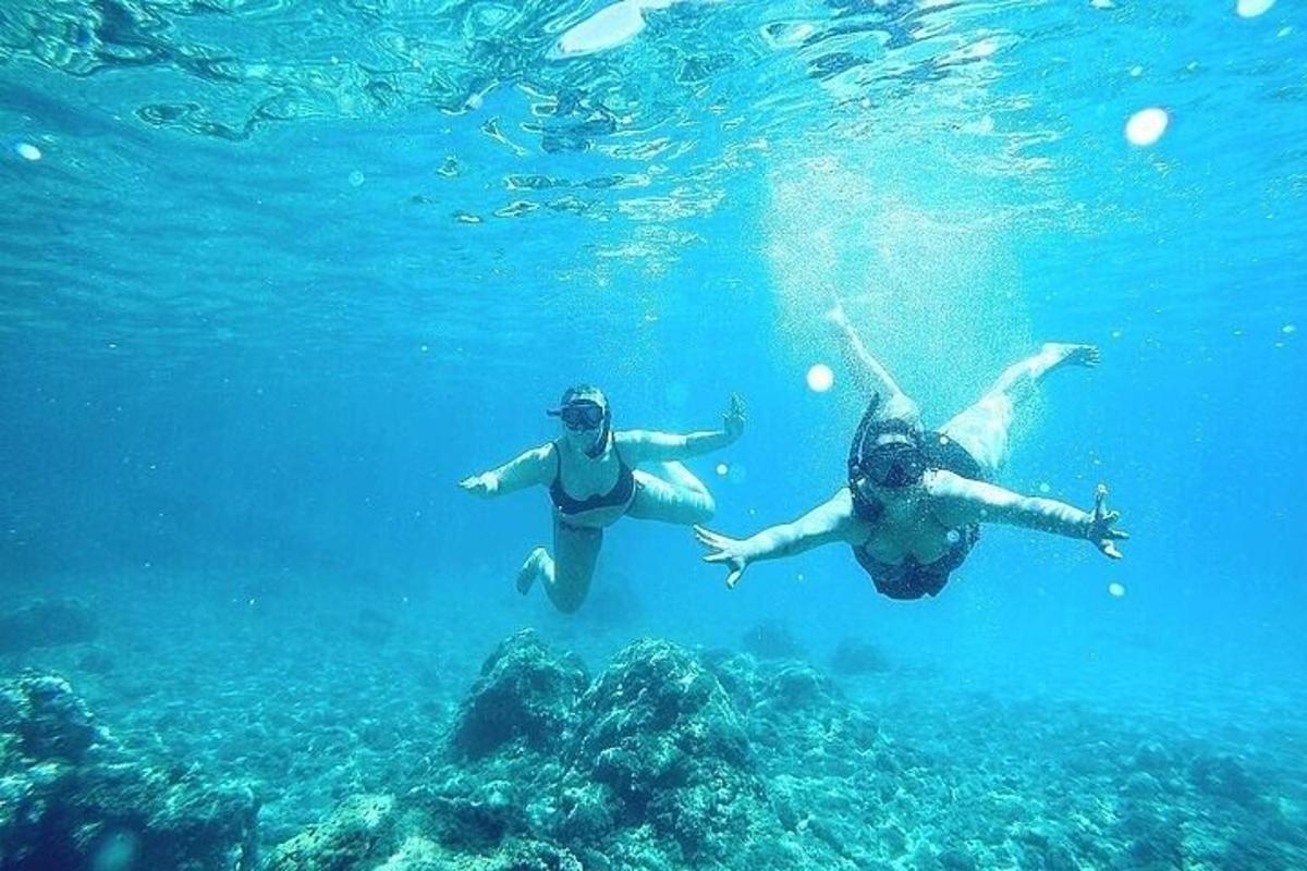 two people swimming in the water in the ocean
