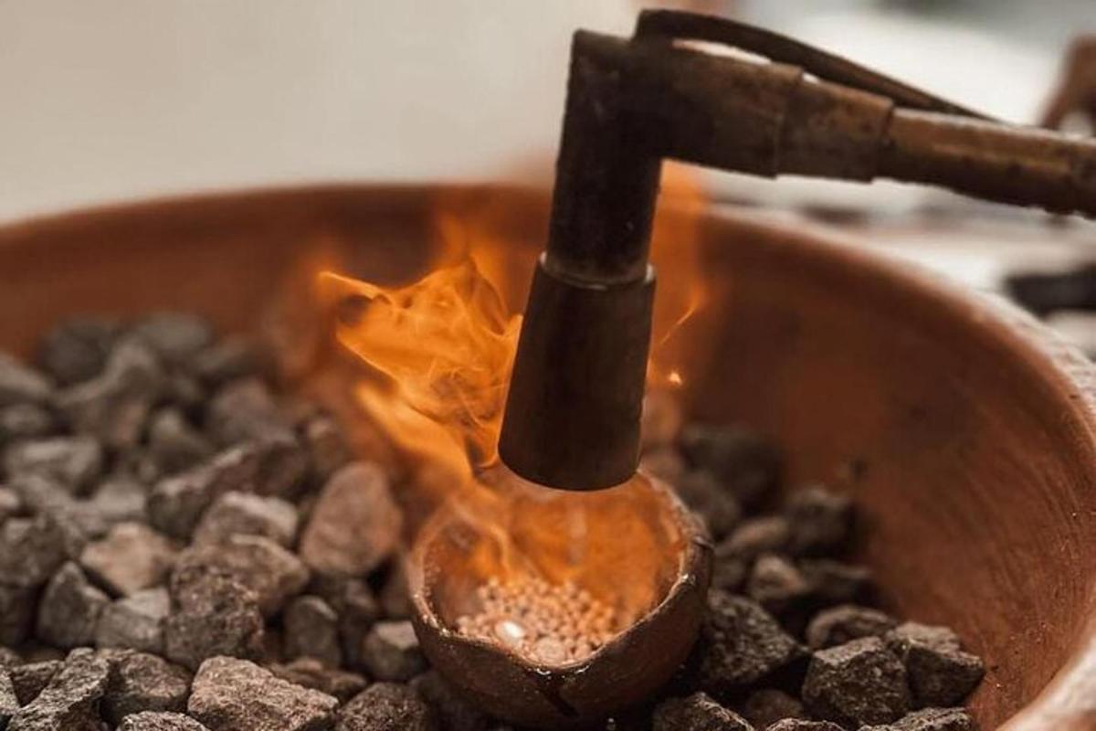a spoon in a pot with fire in it