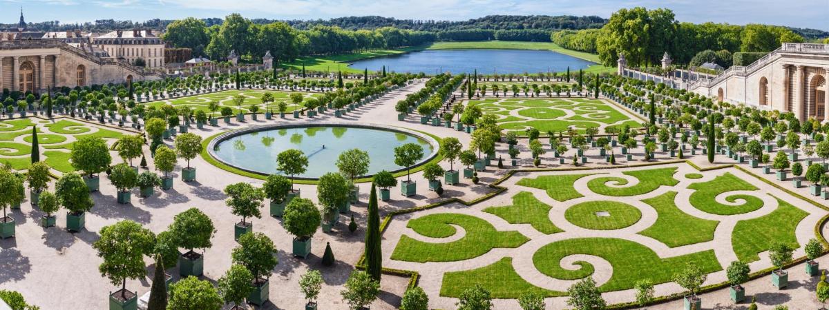 an aerial view of a garden with a lake