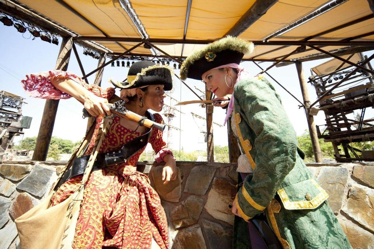 two people dressed in costumes standing under a tent